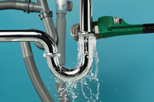 A burst pipe, representing home water winter damage in Georgia