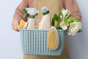 A woman gathering spring cleaning supplies to prepare for spring cleaning in Augusta.