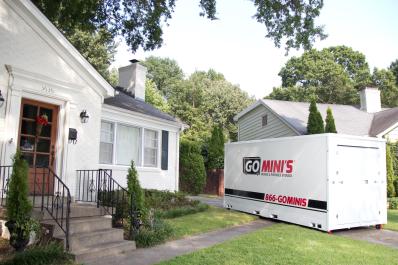 Go Mini's storage container in driveway next to a white one-story house