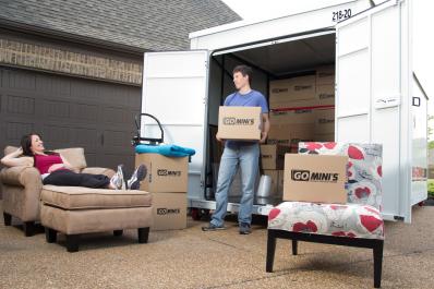 Happy couple unloading boxes