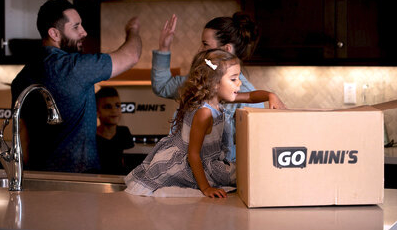 Family unpacking Go Mini's moving box